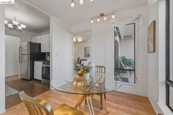 Dining room with suspended lighting and light wood finished floors
