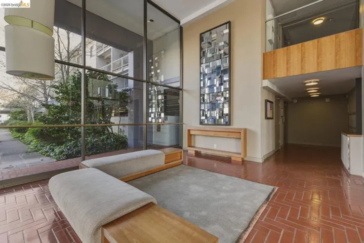 Common area with a high ceiling and expansive windows