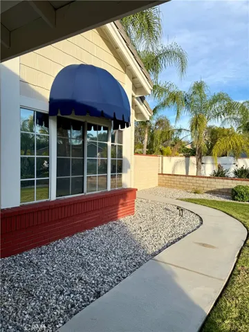 Side walk leads to gate that leads to side/ back yard and pool