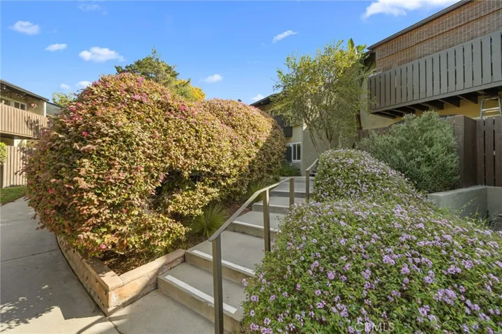 Landscaped walkway up to the unit, tucked away