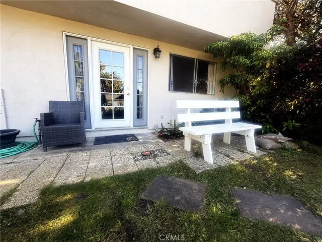 A separate exterior entrance through French doors opening to a small outdoor patio area perfect for relaxing.