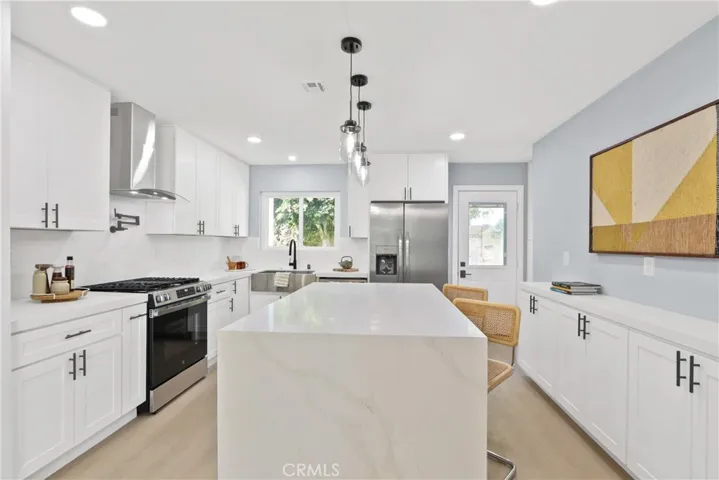 KITCHEN FEATURING BEATIFUL WATERFALL QUARTZ ISLAND