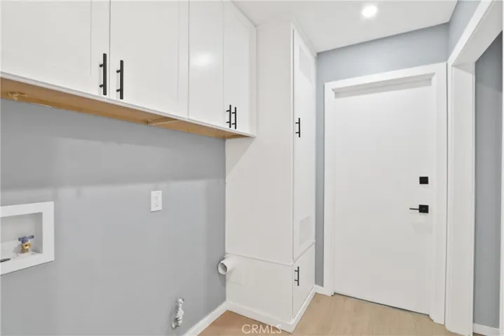 LAUNDRY ROOM LEADING TO TWO CAR GARAGE