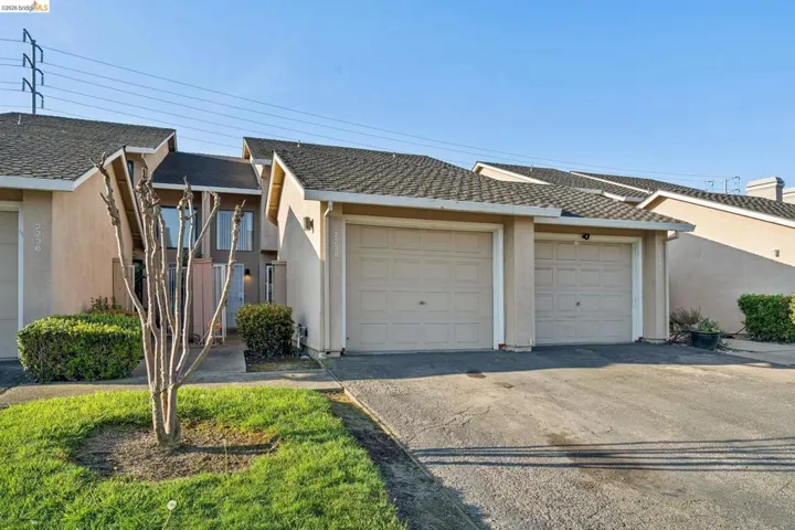 Ranch-style home with stucco siding, driveway, and a garage
