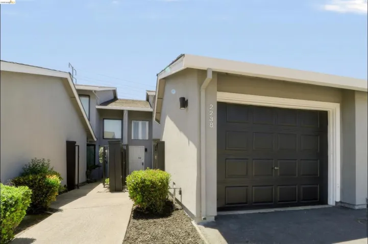 Attached single-car garage featuring a paneled door