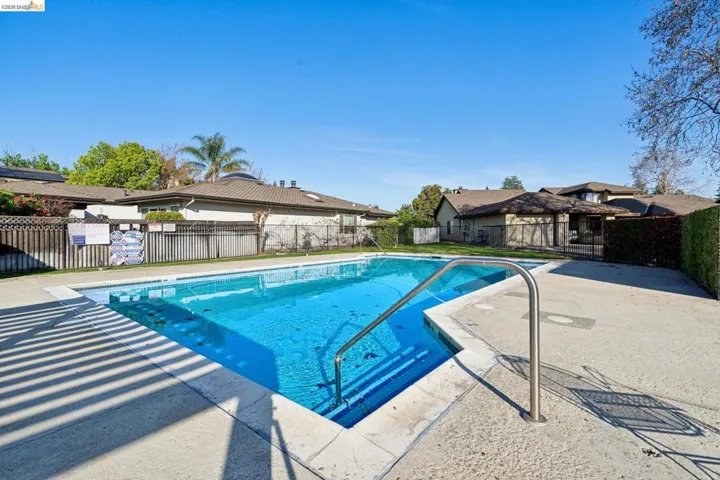 Community pool featuring a patio