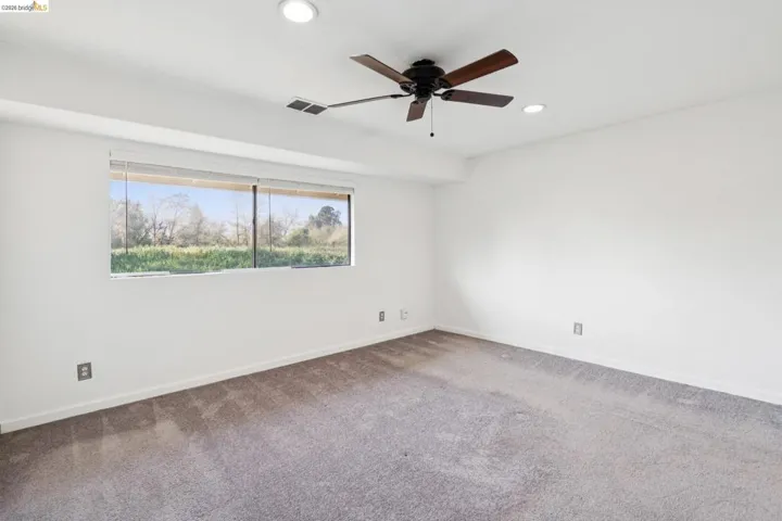 Empty room with ceiling fan, carpet flooring, and recessed lighting
