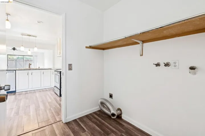 Laundry area featuring electric dryer hookup, light wood-style flooring, and hookup for a washing machine