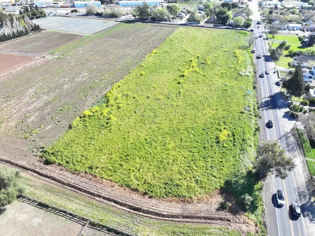 Aerial view of sparsely populated area featuring rows of crops