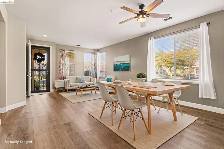 Dining area featuring light wood-style floors, a ceiling fan, plenty of natural light, and recessed lighting