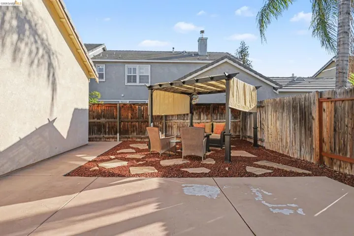 Fenced backyard with a patio area and outdoor dining area
