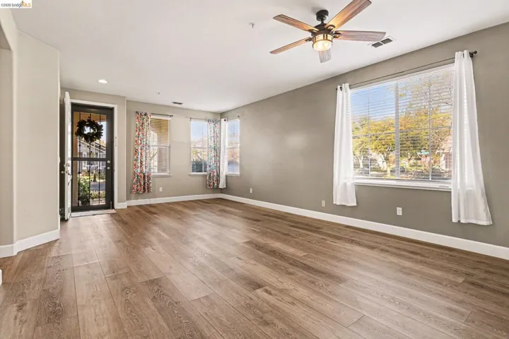 Unfurnished room featuring a ceiling fan, light wood-style floors, healthy amount of natural light, and recessed lighting