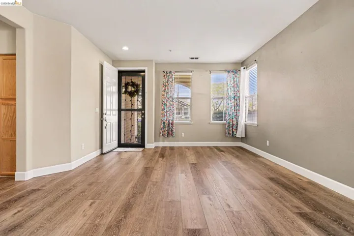 Empty room featuring light wood-type flooring and recessed lighting