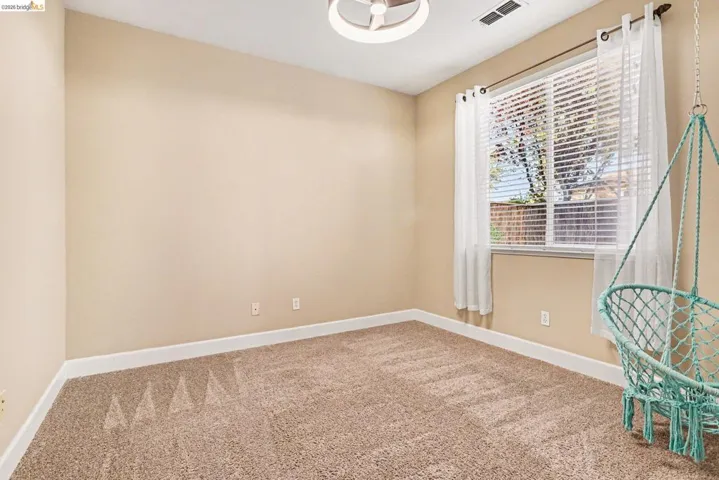 Unfurnished room with baseboards and light carpet