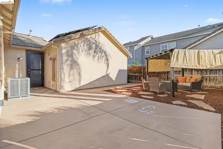 Fenced backyard with a patio and an outdoor hangout area