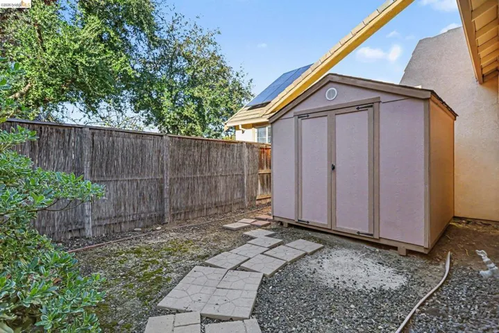 View of shed featuring a fenced backyard
