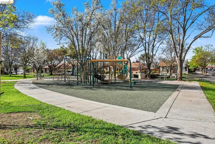 Community jungle gym featuring a residential view and a lawn