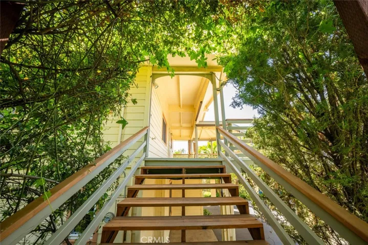 Redwood steps take you to the second level front door.