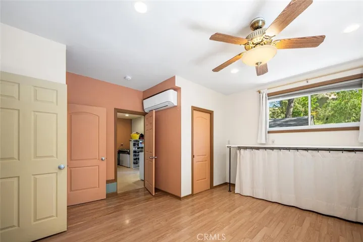 Laundry room through the center door and more storage behind the door to the right.