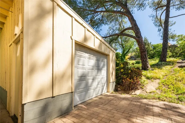 A single car garage sits at the back of the home.