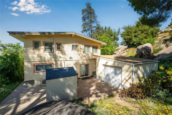 A single car detached garage sits behind the home.