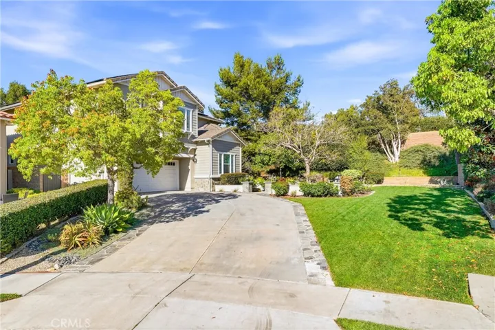 Set back ideally at the end of a cul-de-sac with a long driveway and park-like setting
