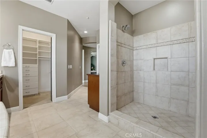 Spacious shower and two walk-in closets with built-ins.