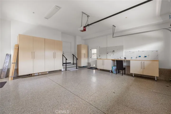 Garage has custom built in cabinetry for extra storage.