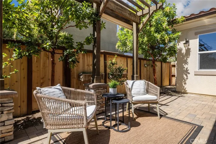 Picturesque pergola overhang for shade and privacy in the patio.