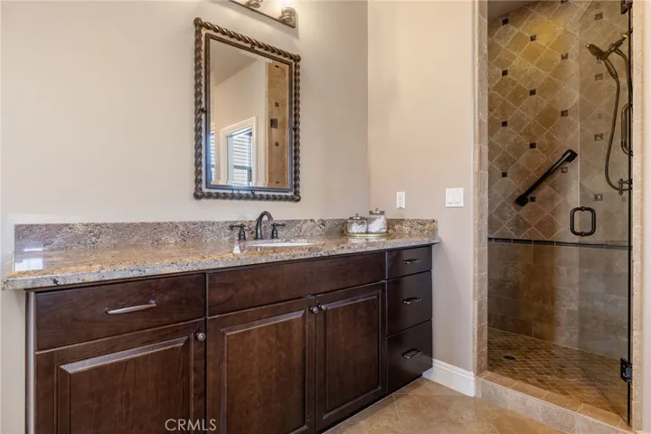 Primary bathroom has a walk in shower and dual sinks.