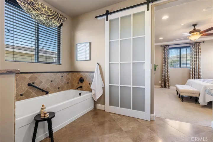 Primary bathroom has walk in shower and soaking tub.