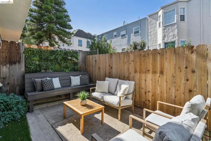 Fenced backyard with an outdoor hangout area and a patio area