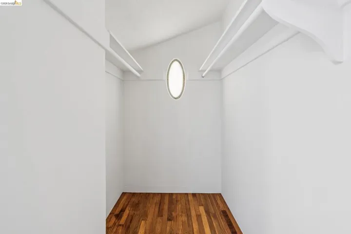 Walk in closet featuring wood finished floors