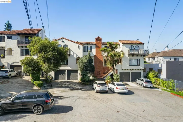 View of front of property with stucco siding, a chimney, and a tile roof