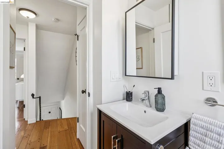Half bath with vanity and wood-type flooring