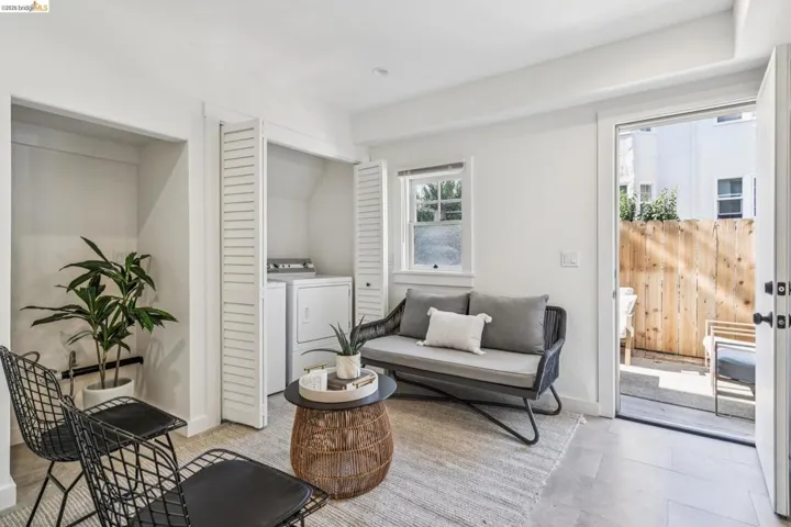 Living area featuring vaulted ceiling and separate washer and dryer