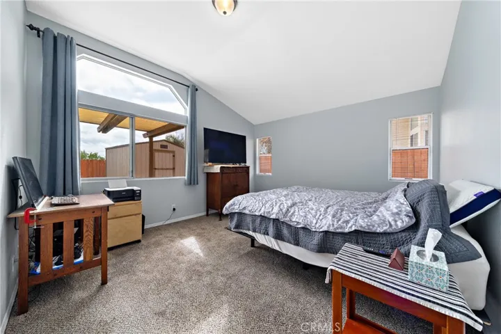 Spacious Primary Bedroom With Large Window And Vaulted Ceiling
