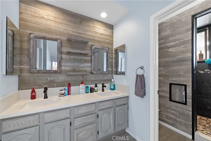 Primary Bathroom With Dual Sink Vanity And Custom Tile Accent Wall
