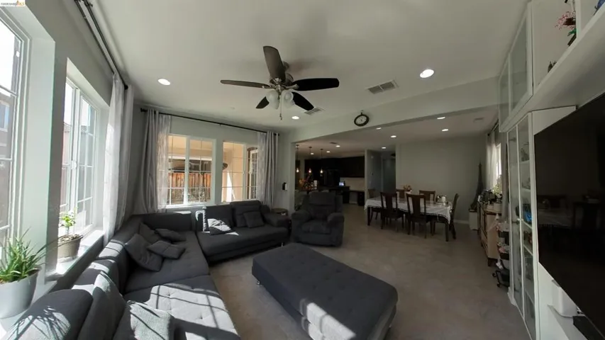 Living area with a ceiling fan and recessed lighting