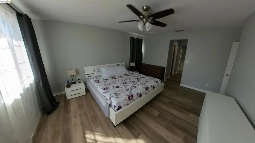 Bedroom featuring dark wood finished floors and a ceiling fan
