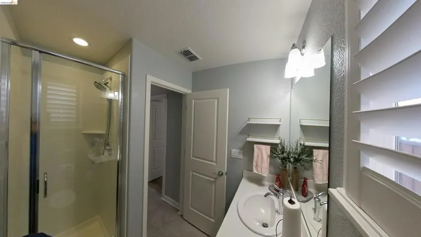 Full bath featuring vanity and a shower stall
