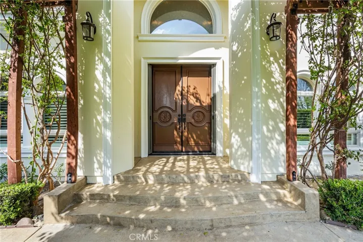front door with gorgeous flowering vines providing shade