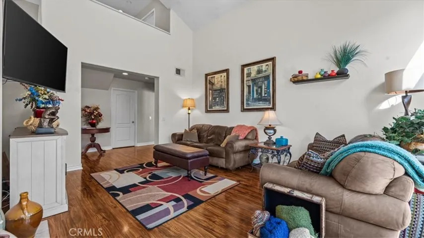 Spacious and airy, this living area features high ceilings, warm finishes, and a seamless flow into adjacent spaces, creating a comfortable setting for gatherings.