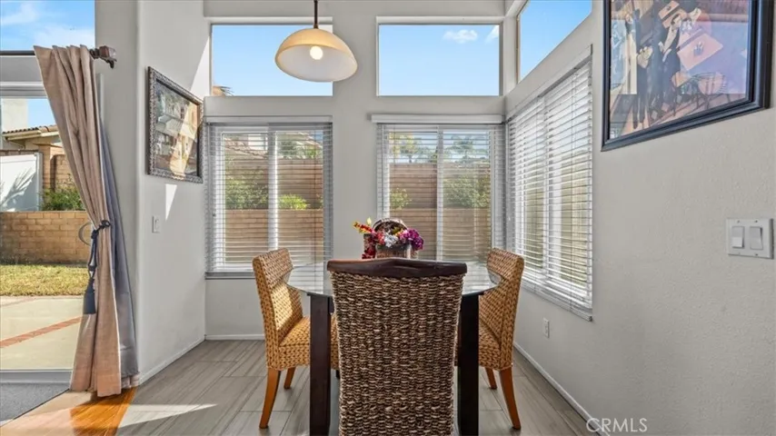 A charming breakfast area surrounded by windows, offering plenty of natural light and a cozy spot for casual dining with views of the outdoor space.