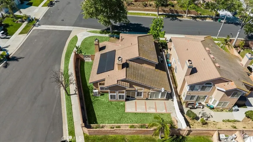 Bird’s-eye view showcasing the property’s position within the neighborhood, including surrounding homes and nearby streets.