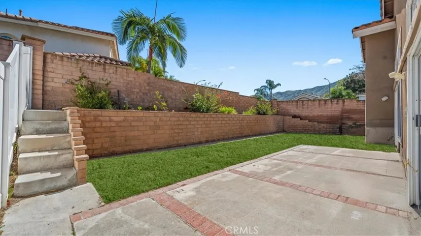 The private backyard features a spacious patio area and low-maintenance landscaping, offering a great setting for outdoor dining or relaxation.