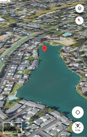Aerial view of property and surrounding area with nearby suburban area and a nearby body of water