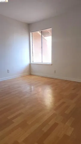 Unfurnished room with light wood-type flooring and baseboards