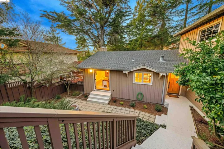 View of front of property with roof with shingles, a fenced front yard, a chimney, and board and batten siding