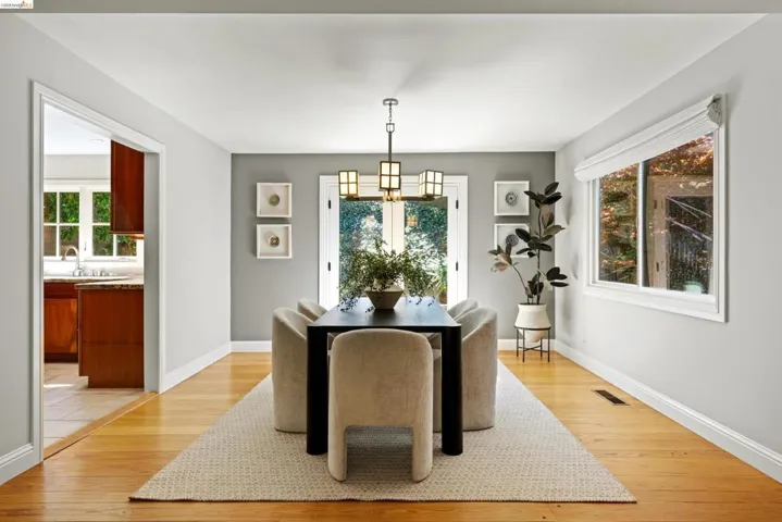 Dining area featuring light wood-type flooring and suspended lighting
